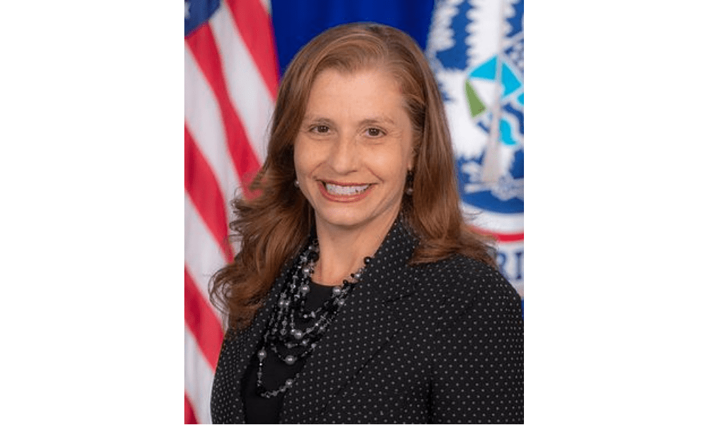Smiling woman in front of American flag