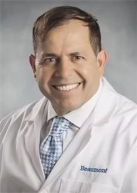 Man in white lab coat smiling