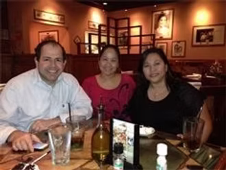 Group smiling at a dinner table