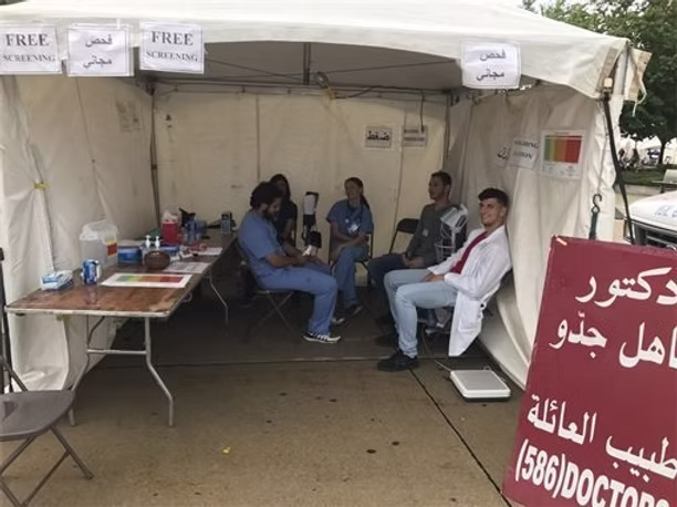 Medical tent with people sitting inside