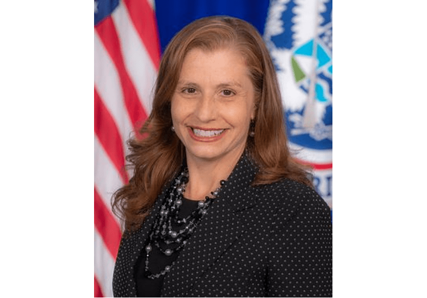 Smiling woman in front of American flag