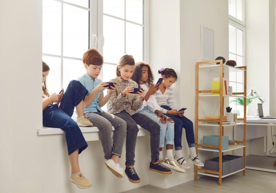Group of children engaged with phones