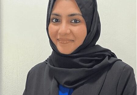 Confident woman in black headscarf, smiling